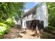 View of the back of the house featuring a screened-in porch and a partially wooded lot at 804 Town Side Dr, Apex, NC 27502