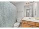 Simple bathroom with shower, toilet, vanity and patterned curtain at 804 Town Side Dr, Apex, NC 27502