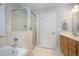 Well-lit bathroom featuring a shower and bathtub with glass door at 804 Town Side Dr, Apex, NC 27502