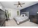 Cozy bedroom with plush carpet, ceiling fan, and natural light at 804 Town Side Dr, Apex, NC 27502