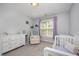 Bright and spacious bedroom with large window and comfortable seating area at 804 Town Side Dr, Apex, NC 27502