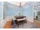 Stylish dining room with coffered ceiling, and a patterned rug under the dark table at 804 Town Side Dr, Apex, NC 27502