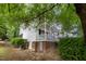 Two-story home with white siding, brick foundation, and a covered front porch at 804 Town Side Dr, Apex, NC 27502