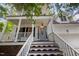 Inviting entryway with stairs leading to a covered porch with a light blue front door at 804 Town Side Dr, Apex, NC 27502
