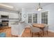 Cozy eat-in kitchen nook with bright cabinets, stainless appliances, and natural light at 804 Town Side Dr, Apex, NC 27502