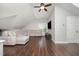 Spacious living room with a large sectional sofa, hardwood floors, and a ceiling fan at 804 Town Side Dr, Apex, NC 27502