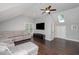 Bright living room with hardwood floors, a large sectional sofa, skylight, and television at 804 Town Side Dr, Apex, NC 27502