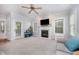 Bright living room with fireplace, neutral walls, and a door leading to the outside at 804 Town Side Dr, Apex, NC 27502