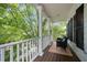 Covered porch is a relaxing spot with white columns, a wooden floor, and outdoor furniture at 804 Town Side Dr, Apex, NC 27502