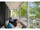 Inviting covered porch features a seating area with outdoor chairs, cushions, and views of nature at 804 Town Side Dr, Apex, NC 27502