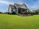 Expansive backyard featuring a screened-in porch and lush landscaping, perfect for outdoor living at 83 Sawyer Ct, Wendell, NC 27591