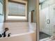 Modern bathroom showcasing a glass enclosed shower, bathtub and stylish fixtures at 83 Sawyer Ct, Wendell, NC 27591