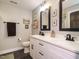 Stylish bathroom boasts a dual sink vanity, modern black fixtures, and chic framed artwork at 83 Sawyer Ct, Wendell, NC 27591