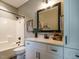 This well lit bathroom features a vanity with drawers and shelves, a toilet and a shower/tub at 83 Sawyer Ct, Wendell, NC 27591