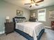 Cozy bedroom showcasing a comfortable bed, soft gray walls, and an elegant ceiling fan at 83 Sawyer Ct, Wendell, NC 27591