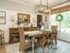 Charming dining room featuring a wooden table, modern light fixture, and ample natural light at 83 Sawyer Ct, Wendell, NC 27591