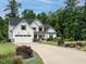 Beautiful white house with black shutters, landscaped yard, and a long concrete driveway at 83 Sawyer Ct, Wendell, NC 27591