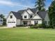 Beautiful two-story white house with a well-manicured front yard, and a convenient two-car garage at 83 Sawyer Ct, Wendell, NC 27591