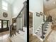 Elegant two story foyer featuring hardwood floors, stairwell, and natural light from a nearby window at 83 Sawyer Ct, Wendell, NC 27591