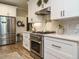 Modern kitchen featuring stainless steel appliances, light countertops, and white cabinetry at 83 Sawyer Ct, Wendell, NC 27591