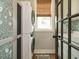 Bright laundry room features a stacked washer/dryer, floral wallpaper and a window with natural light at 83 Sawyer Ct, Wendell, NC 27591