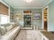 Cozy living room featuring neutral tones, comfortable seating, and decorative bookshelf at 83 Sawyer Ct, Wendell, NC 27591