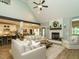Inviting living room featuring a white brick fireplace, ceiling fan, and an open floor plan at 83 Sawyer Ct, Wendell, NC 27591