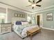 Inviting bedroom boasts trey ceiling, upholstered bed and an ensuite bathroom at 83 Sawyer Ct, Wendell, NC 27591