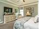 Relaxing bedroom showcases stylish decor, dresser and a comfortable accent chair near the window at 83 Sawyer Ct, Wendell, NC 27591