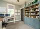 Office space features a large blue bookcase and work space with natural light at 83 Sawyer Ct, Wendell, NC 27591