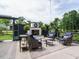 Relaxing outdoor seating area features a charming brick fireplace, comfortable seating, and beautiful landscaping at 83 Sawyer Ct, Wendell, NC 27591