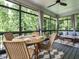 Elegant screened porch with comfortable seating, a dining table, and a serene view of the lush surroundings at 83 Sawyer Ct, Wendell, NC 27591