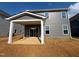 Gray home featuring a backyard patio with white columns and trim and a sliding glass door entrance at 88 Willow Cameron Way, Angier, NC 27501