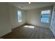 Bright bedroom featuring neutral walls, carpet flooring, and abundant natural light from two windows at 88 Willow Cameron Way, Angier, NC 27501