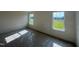 Bedroom with two bright windows offering outdoor views, and awaiting finishing touches at 88 Willow Cameron Way, Angier, NC 27501