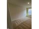 Neutral bedroom featuring carpet flooring, neutral walls, and natural light from the large window at 88 Willow Cameron Way, Angier, NC 27501