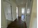 Hallway featuring hardwood floors and white doors leading to different rooms at 88 Willow Cameron Way, Angier, NC 27501