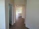 Hallway view of the kitchen featuring white cabinets and island at 88 Willow Cameron Way, Angier, NC 27501