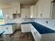 Bright kitchen features white cabinetry, subway tile backsplash and countertops covered in protective film at 88 Willow Cameron Way, Angier, NC 27501