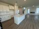 Open kitchen featuring an island, stainless steel appliances, and white cabinets at 88 Willow Cameron Way, Angier, NC 27501