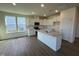 Open kitchen featuring an island, stainless steel appliances, and white cabinets at 88 Willow Cameron Way, Angier, NC 27501