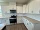 Kitchen with white cabinets, stainless steel appliances, and light-colored quartz counters at 88 Willow Cameron Way, Angier, NC 27501