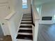 Bright staircase features stained treads, white risers and white painted stringers at 88 Willow Cameron Way, Angier, NC 27501