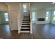Stairway leading to second floor of home and open-concept living area at 88 Willow Cameron Way, Angier, NC 27501