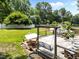 Large backyard with a deck including a hammock, porch swing, and outdoor furniture at 8808 Colesbury Dr, Raleigh, NC 27615