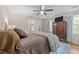 Bedroom with wood flooring, a ceiling fan, and good natural lighting at 8808 Colesbury Dr, Raleigh, NC 27615
