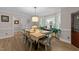 Dining room boasts natural light from bay window and a decorative light fixture over the dining table at 8808 Colesbury Dr, Raleigh, NC 27615