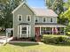 Charming two-story home with green siding, white trim, bay window and a welcoming front porch at 8808 Colesbury Dr, Raleigh, NC 27615