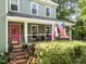 View of the home's inviting front porch and pink front door, perfect for relaxing at 8808 Colesbury Dr, Raleigh, NC 27615