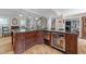 Kitchen island with seating, wine cooler, and custom cabinets, perfect for entertaining at 8808 Colesbury Dr, Raleigh, NC 27615
